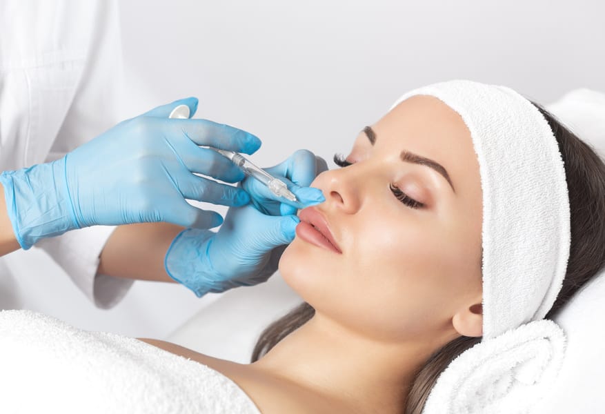 Beauty Woman getting Dermal filler injectables on Lips in Madisonville