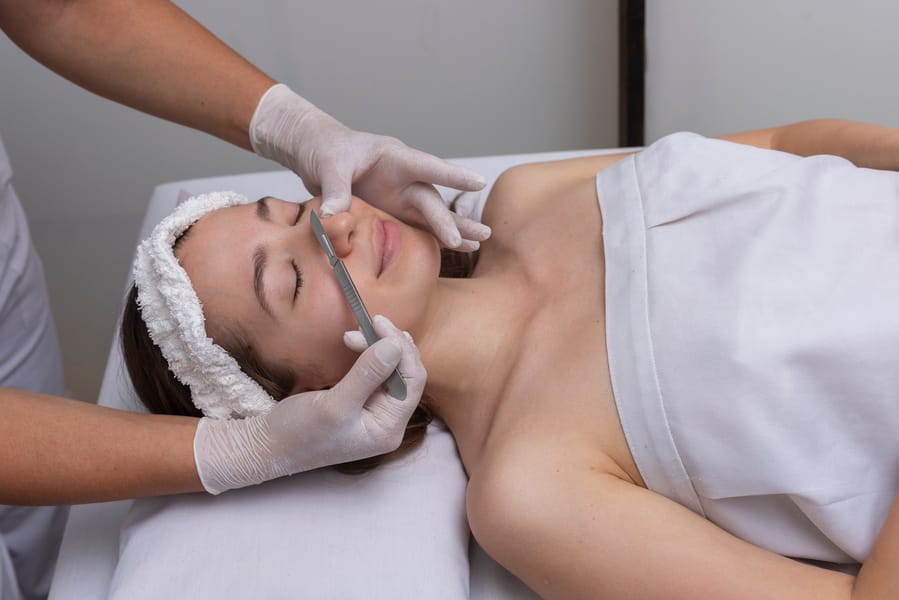 Medspa Doctor giving Dermaplaning service to a Woman | Hollrah Wellness