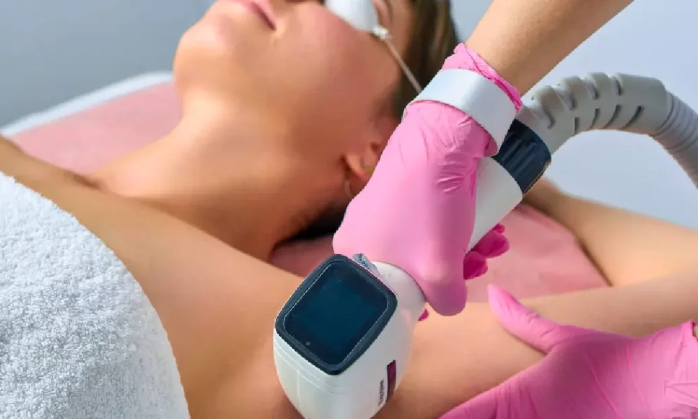 woman receiving laser hair removal on her underarm using a Diolaze device in Madisonville, LA